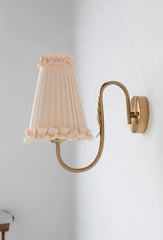warm ambient wall sconce with tassel-trim shade for bedroom or hallway lighting