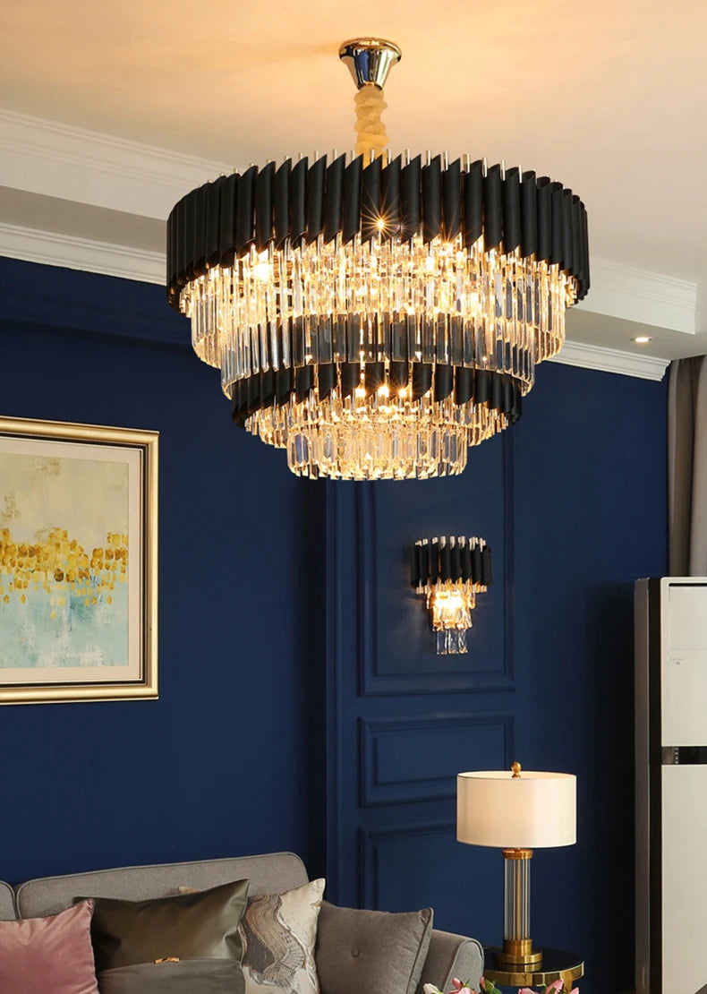 Luxurious chandelier hanging in a room with blue walls and a gray sofa.