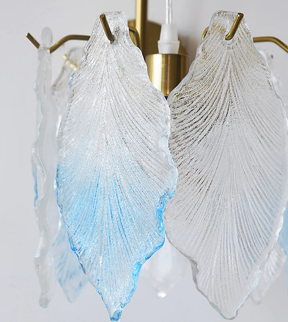 Decorative wall sconces with leaf-shaped glass shades on a white background