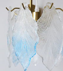 Decorative wall sconces with leaf-shaped glass shades on a white background