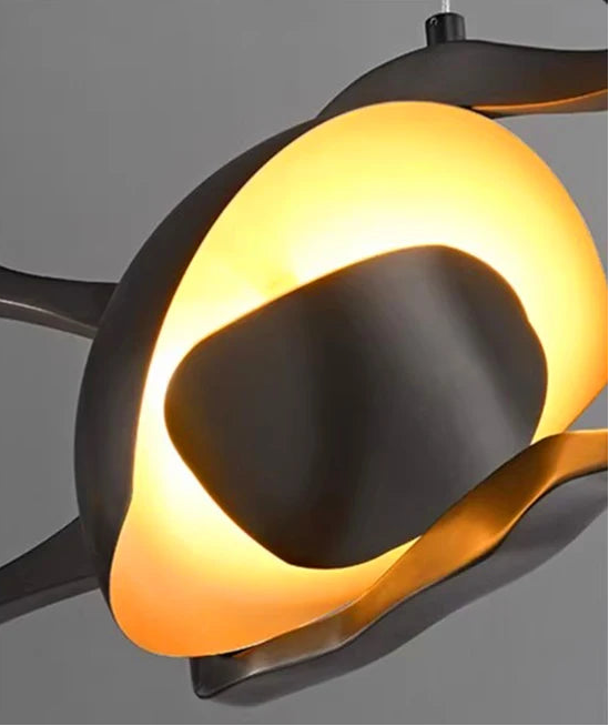 Modern ceiling light fixture with orange and black design on a gray background