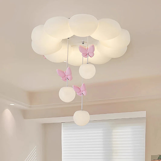 White cloud-shaped ceiling light with pink butterflies and hanging glass orbs, illuminated.