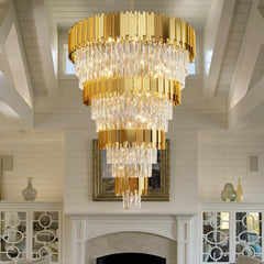 Gold chandelier hanging in a room with white walls and decorative elements.