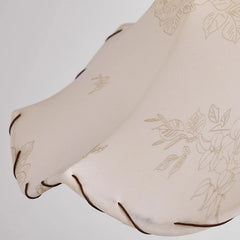 Beige fabric with floral embroidery on a light gray background