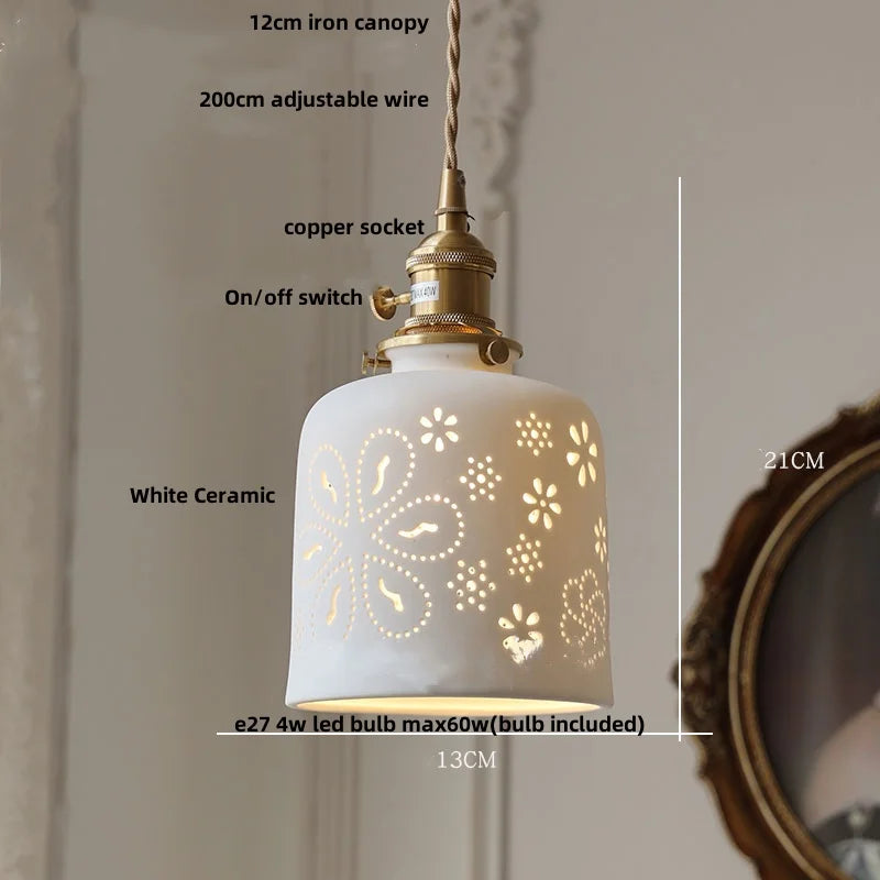 White ceramic pendant light with decorative cut-out design, labeled with dimensions and features.