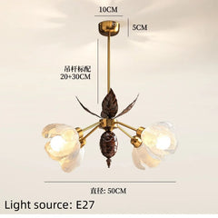 Chandelier with leaf design and measurement details on a beige background