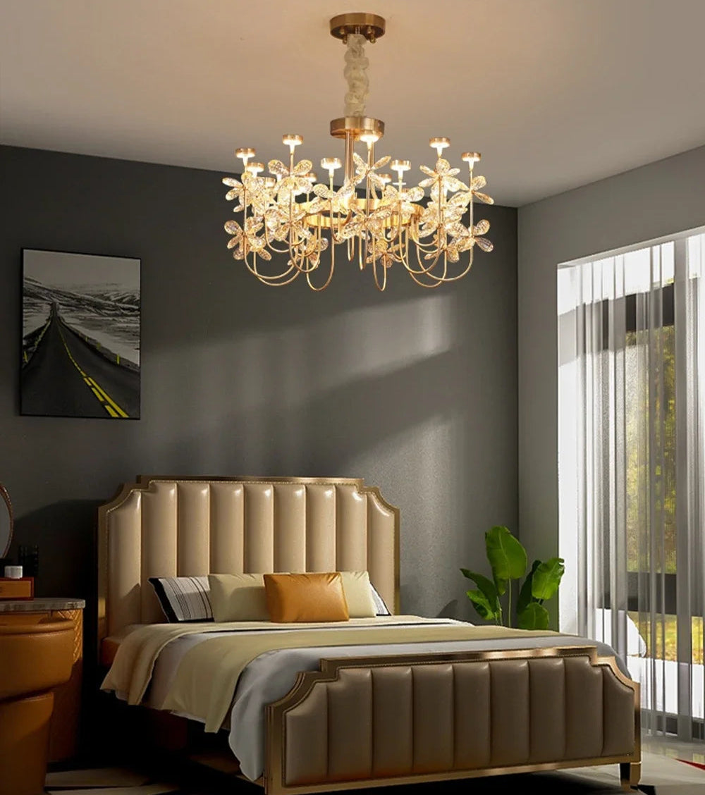 Modern bedroom with a chandelier, bed, and large window.