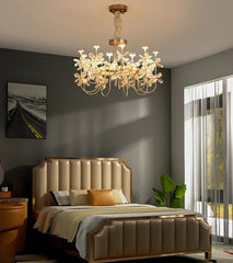 Modern bedroom with a chandelier, bed, and large window.