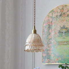 Vintage-style pendant light with floral wall art in the background