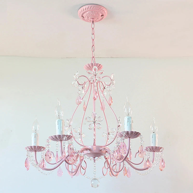 Close-up view of the pink semi-flush mount chandelier, highlighting the crystal flower details and candle-style bulb holders.