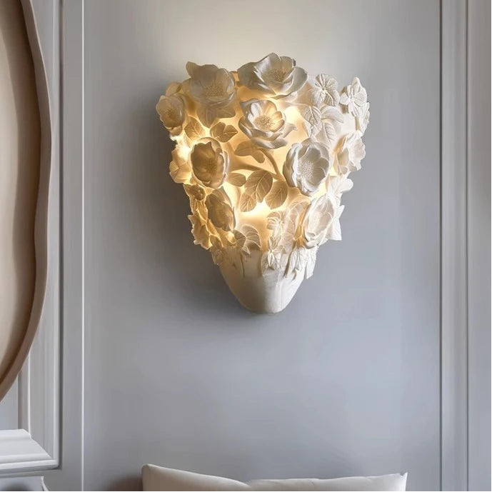 Decorative wall light fixture with floral design on a gray wall, featuring the No.7 Lighting logo.