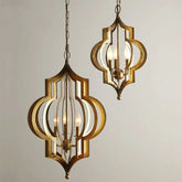 Two gold geometric open frame pendant lights with chain suspension against a white background.