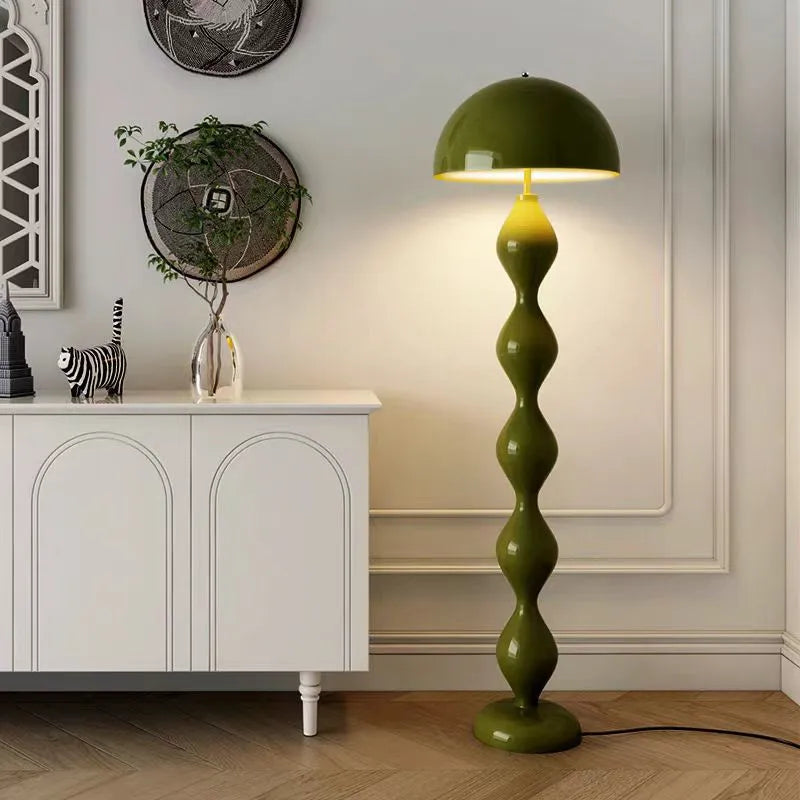 Green mushroom floor lamp with a segmented base in a modern living room setting.