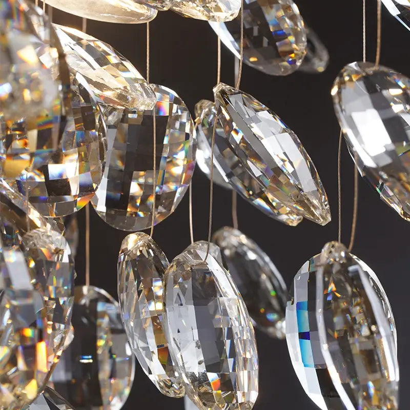 Close-up of crystal chandelier with clear and gold-colored crystals against a dark background