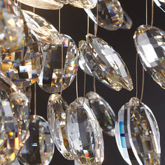 Close-up of crystal chandelier with clear and gold-colored crystals against a dark background
