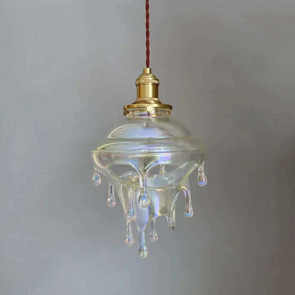 Vintage-style glass pendant light with a droplet design on a plain background