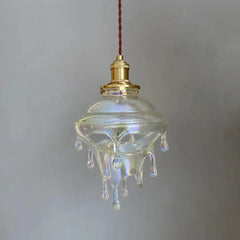 Vintage-style glass pendant light with a droplet design on a plain background