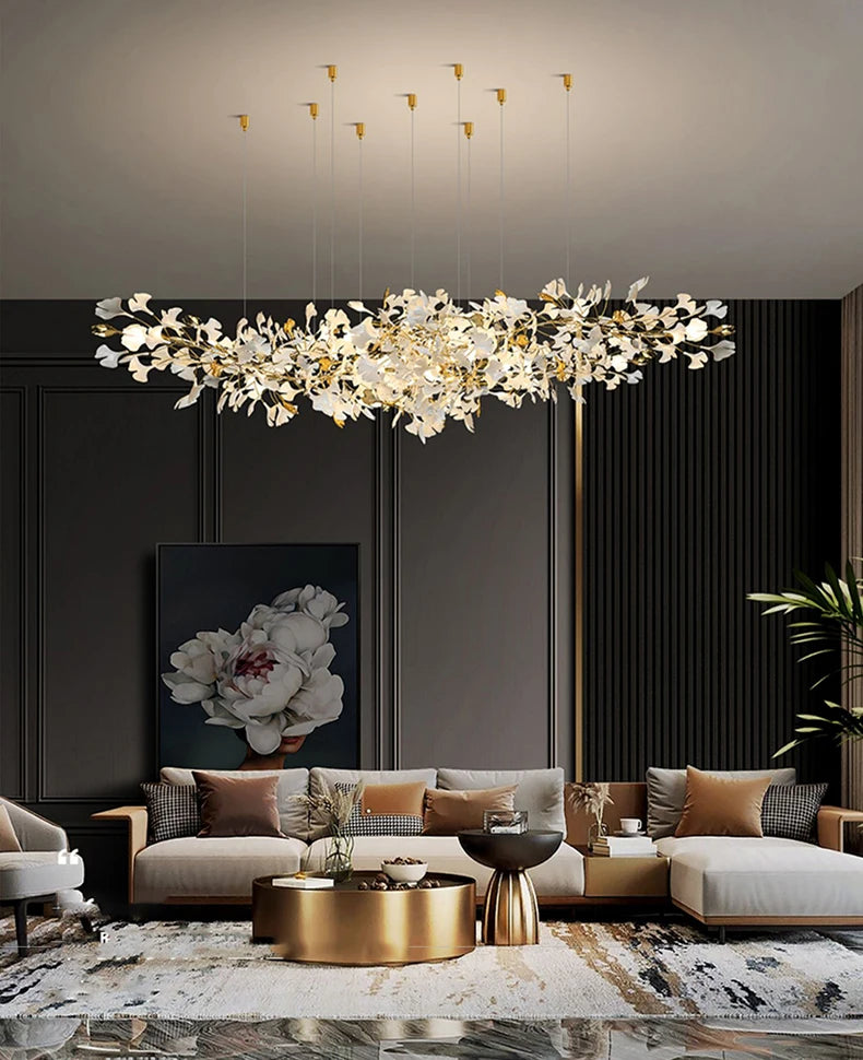 Modern living room with a large chandelier, sofa, and decorative elements.