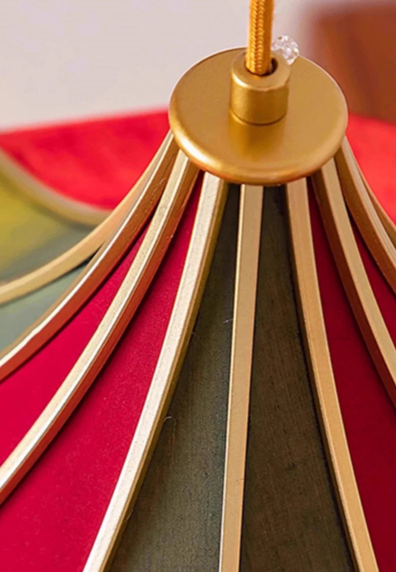 Close-up of a gold lampshade with red fabric underneath