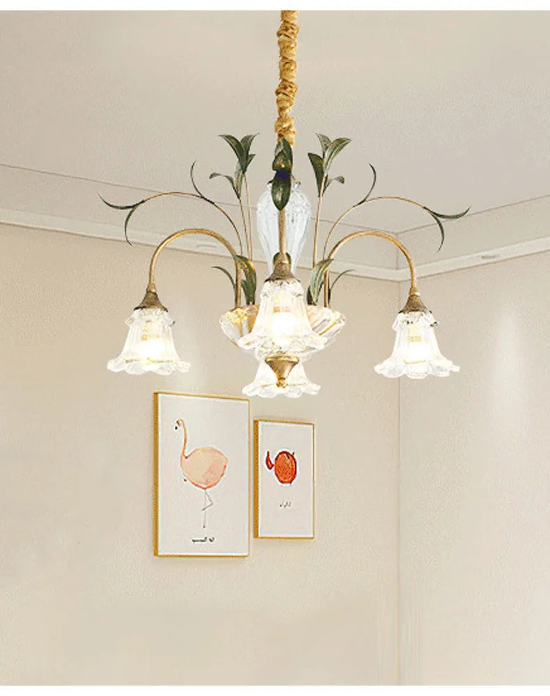 Gold floral crystal semi-flush chandelier installed in a room with artwork
