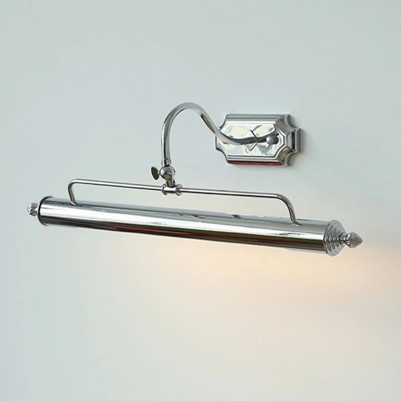 A close-up of a silver-colored linear wall sconce with an adjustable arm and shade, illuminated.