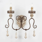Decorative wall sconce with shell accents on a white background