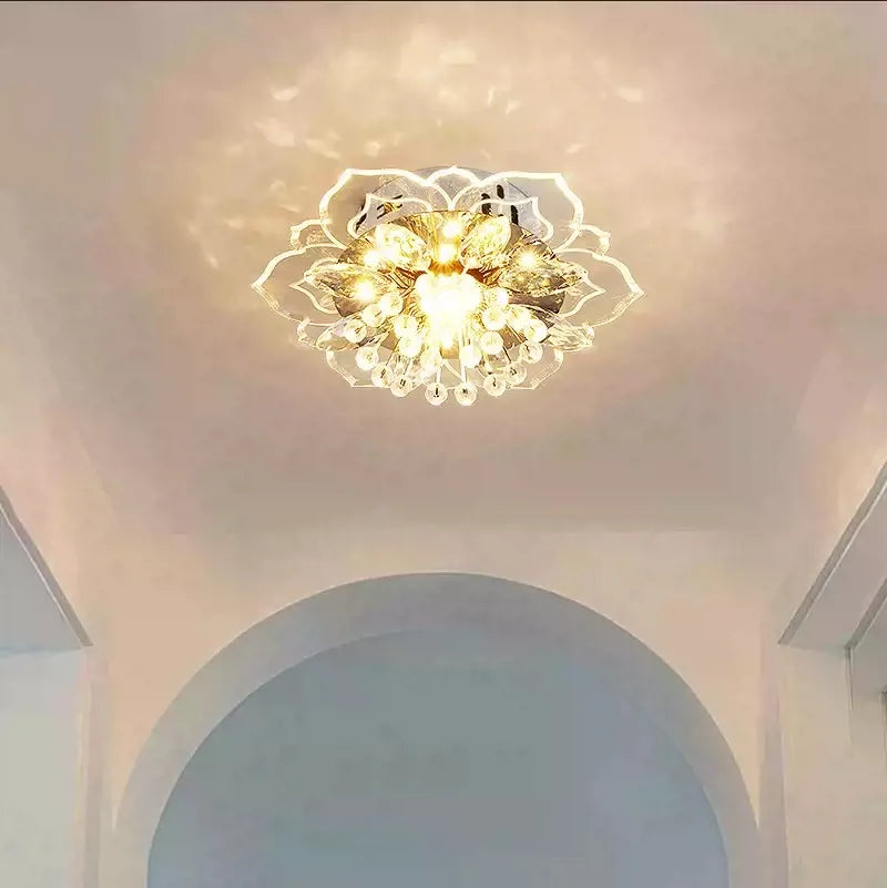 A single gold and crystal floral semi-flush ceiling light illuminating a white ceiling with decorative light patterns.