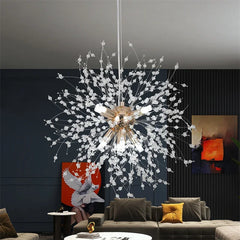 Modern chandelier hanging in a living room with dark walls and a gray sofa.