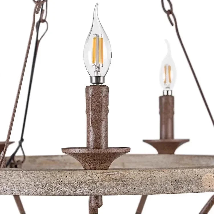 Close-up of a rustic pendant light with wooden candle holders and clear glass shades.