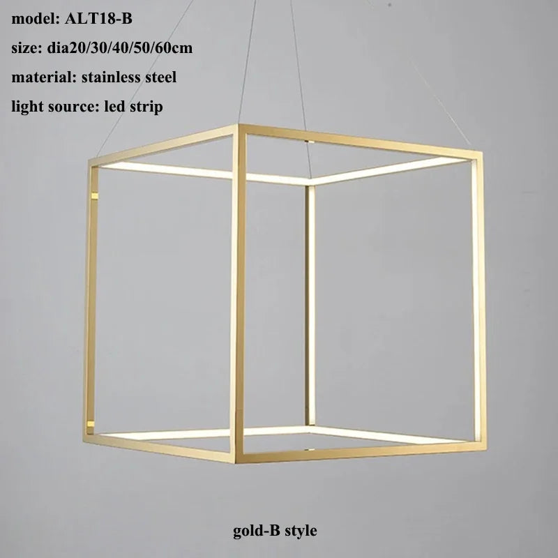 Gold cube-shaped pendant light with LED strip on a gray background