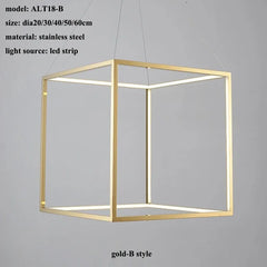 Gold cube-shaped pendant light with LED strip on a gray background