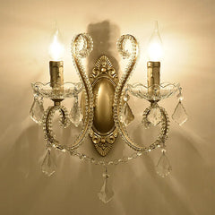 Decorative wall sconce with crystal accents on a beige wall.