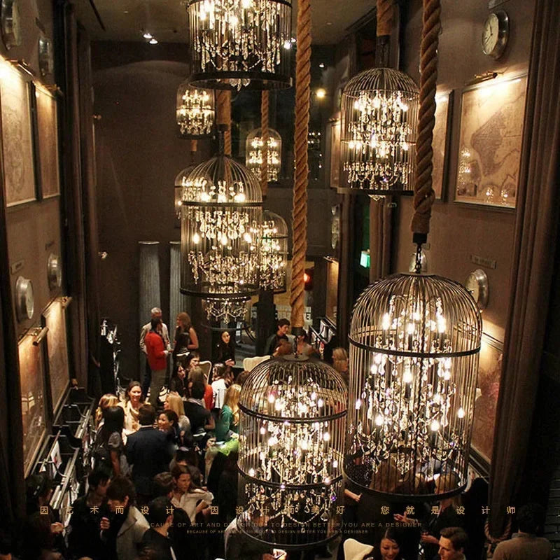 Luxurious interior with hanging chandeliers and people socializing.