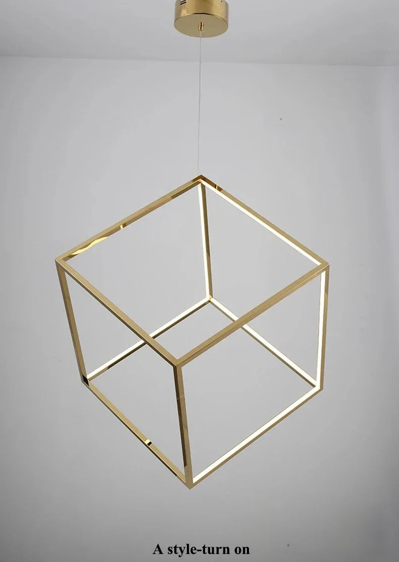 Gold geometric pendant light fixture on a gray background