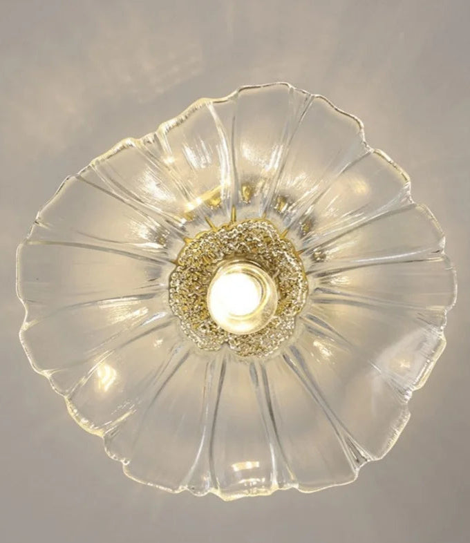 Decorative ceiling light fixture with glass shade on a neutral background