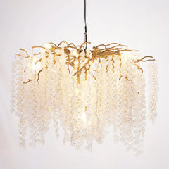 Chandelier with gold branches and white beads on a white background