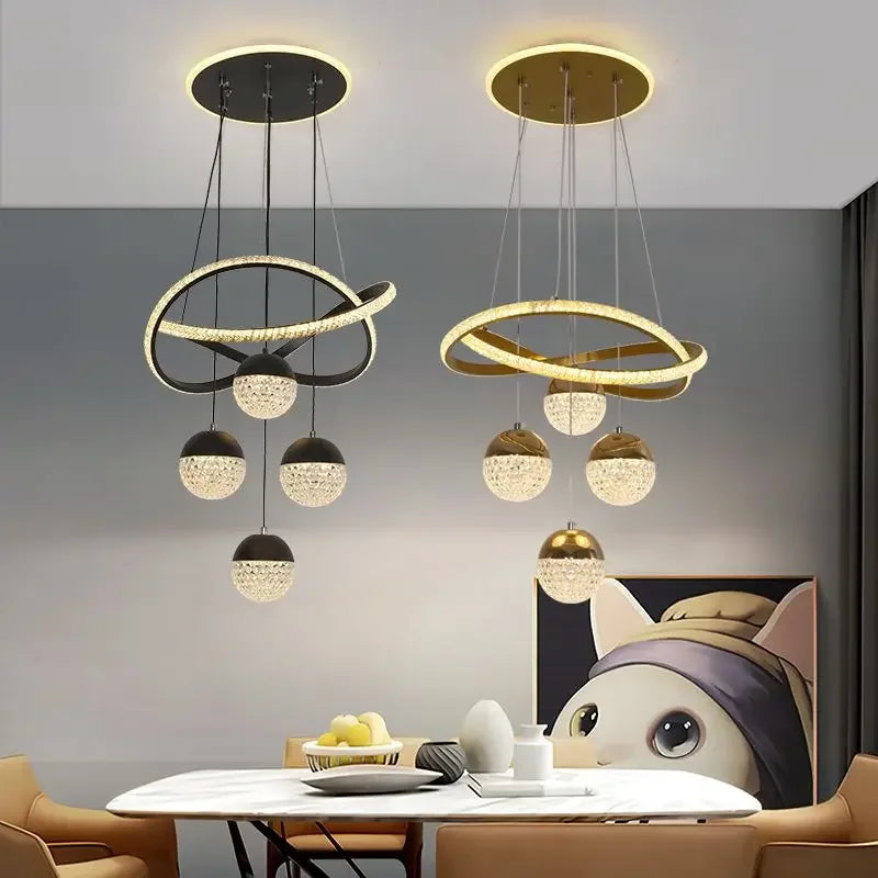 Modern pendant lights hanging above a dining table with a neutral background