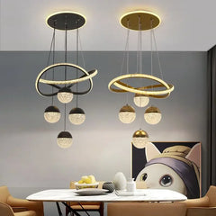 Modern pendant lights hanging above a dining table with a neutral background