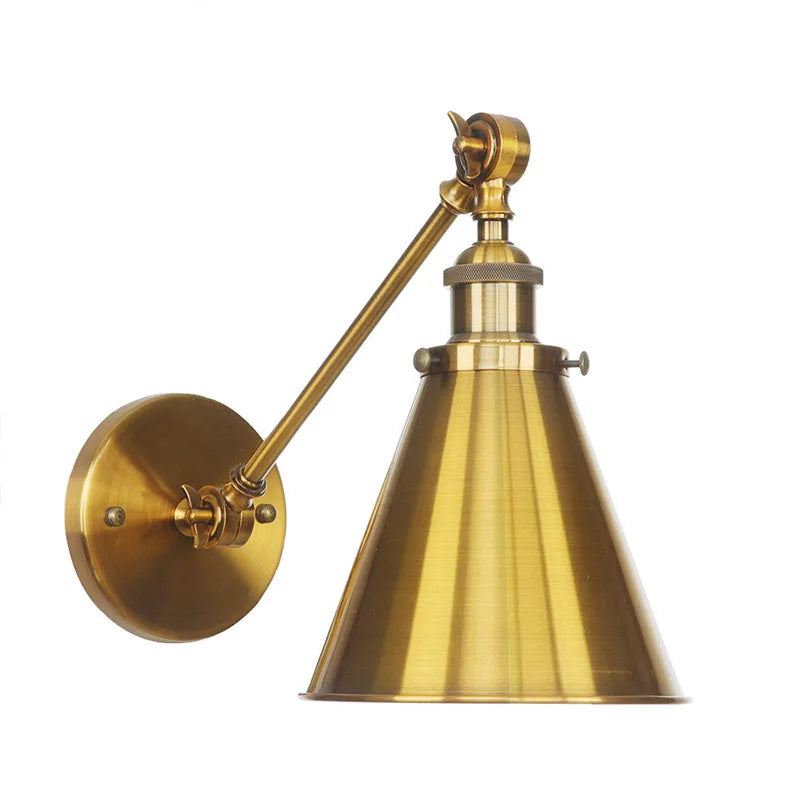 Close-up of the brushed gold finish and articulated arm joints on a wall sconce