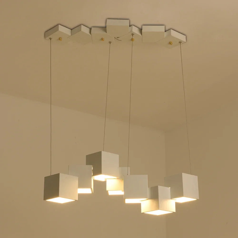Modern chandelier with square light fixtures on a beige ceiling.