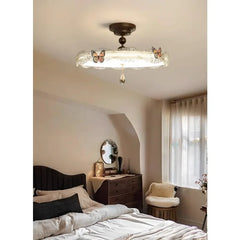 Another bedroom view of the bronze butterfly drum semi-flush ceiling light, showing its placement.