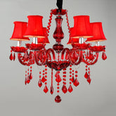 Red crystal chandelier with six fabric shades and cascading crystal droplets, against a grey background.