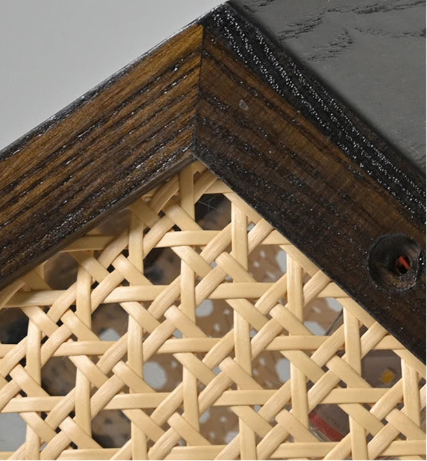 Close-up of a corner with wooden frame and woven wicker design.