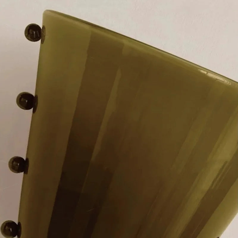 Green rectangular object with rounded corners on a white background