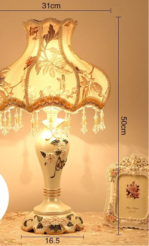 Decorative table lamp with floral design and measurements on a neutral background
