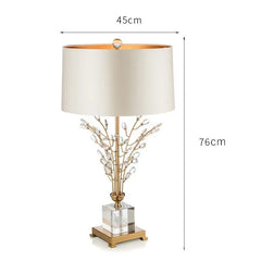 Table lamp with decorative branch design and measurements on a white background