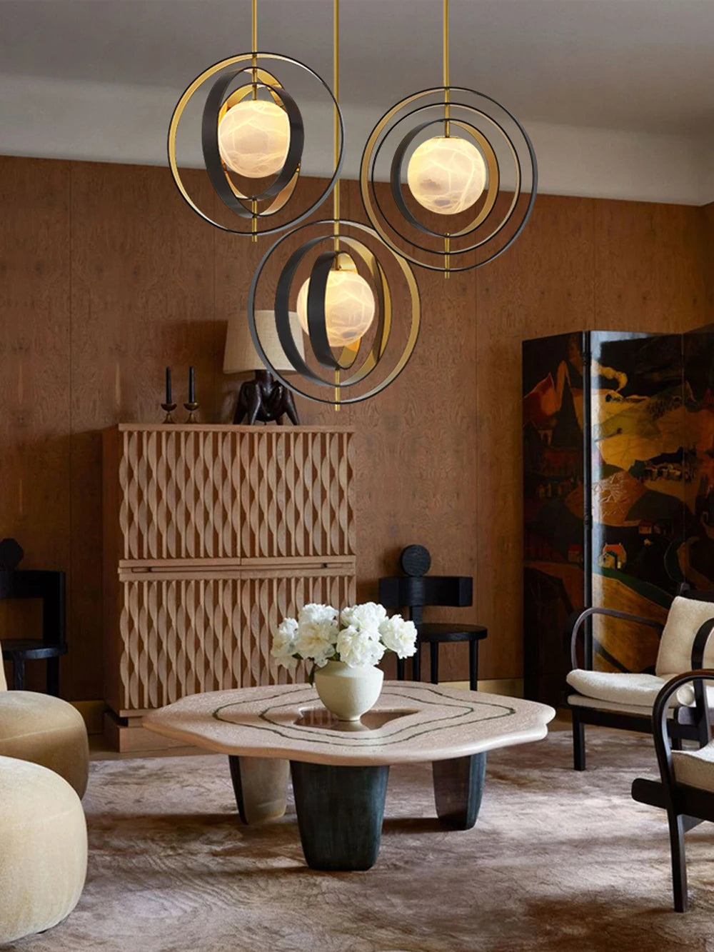 Modern living room with decorative pendant lights, coffee table, and armchair.