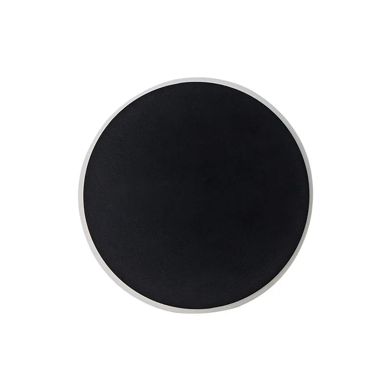 Close-up of a single black circular LED wall light with a white border, isolated on a white background.