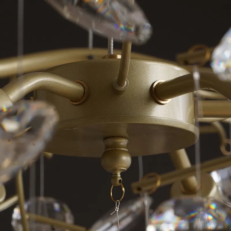 Close-up of a gold chandelier with crystal accents on a dark background