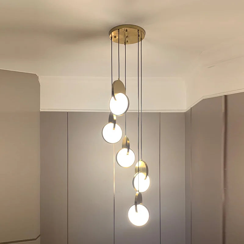 A multi-light chandelier with gold-finished geometric pendants.
